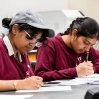 Participants writing on a paper
